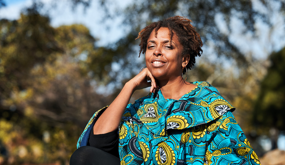 Photograph of artist Charmaine Minniefield sitting in Oakland Cemetery, site of her Flux Projects "Remembrance as Resistance"